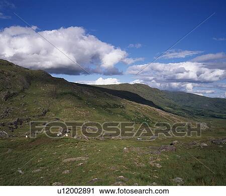 Stock Image - Side of a hill with winding road. Fotosearch