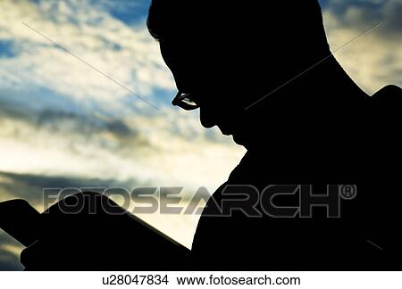 Silhouette of man reading View Large Photo Image Picture - Silhouette of man reading. Fotosearch