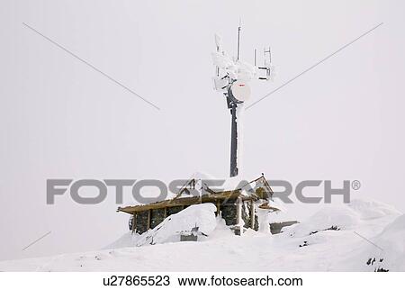 Snow covered building and satellite tower View Large Photo Image Stock Image - Snow covered building and satellite tower. Fotosearch