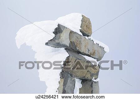 Snow-covered inuksuk View Large Photo Image Stock Image - Snow-covered inuksuk. Fotosearch