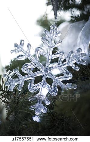 Stock Image - Snowflake holiday ornament on tree. Fotosearch
