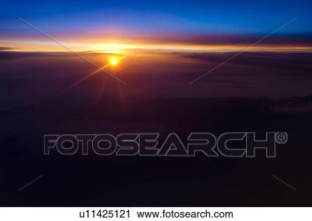 Sunrise over clouds View Large Photo Image Stock Image - Sunrise over clouds. Fotosearch