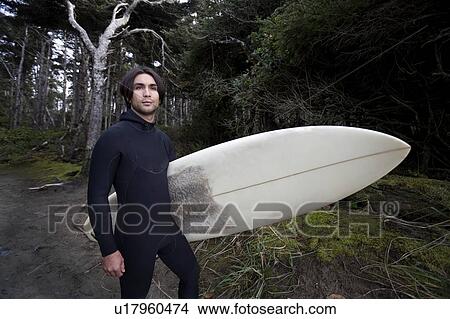 Picture - Surfer by forest. Fotosearch