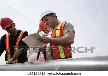 Stock Image - Three construction workers. Fotosearch