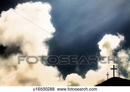 Stock Photo - Three crosses on hill and dramatic clouds. Fotosearch
