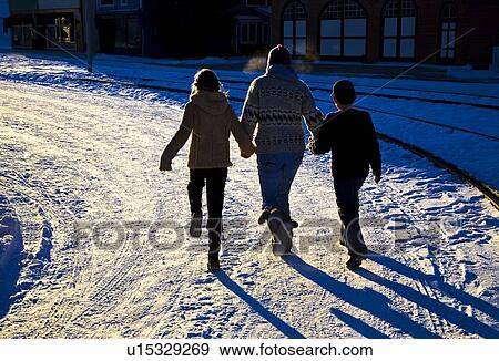 Three people walking on the snow View Large Photo Image Stock Photo - Three people walking on the snow. Fotosearch