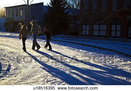 Three people walking on the snow View Large Photo Image Stock Photography - Three people walking on the snow. Fotosearch