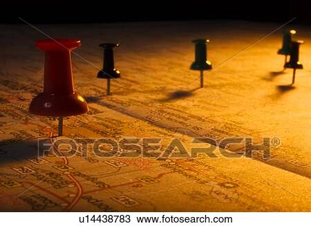 Stock Image - Thumb tacks on a map. Fotosearch