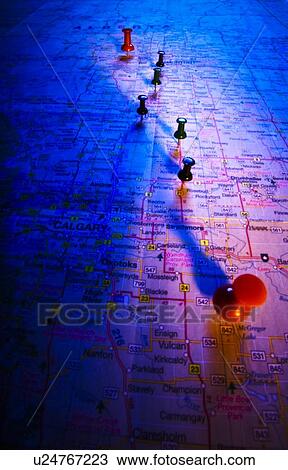 Stock Image - Thumb tacks on a map. Fotosearch