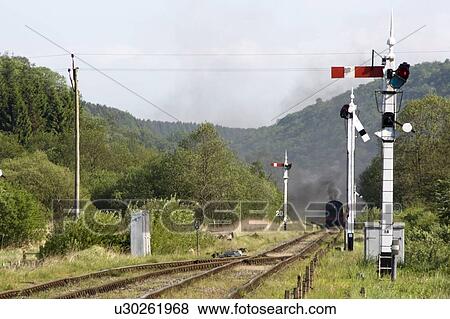 Train Coming Along The Tracks In Levisham, England View Large Photo Image Stock Photo - Train Coming Along The Tracks In Levisham, England. Fotosearch
