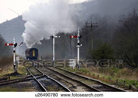 Stock Image - Train on railroad tracks, Grosmont, North Yorkshire, England. Fotosearch
