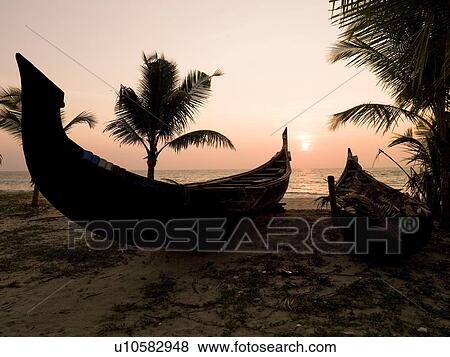 Two canoes on the beach at the Arabian Sea, Kerala, India View Large Photo Image Stock Photo - Two canoes on the beach at the Arabian Sea, Kerala, India . Fotosearch