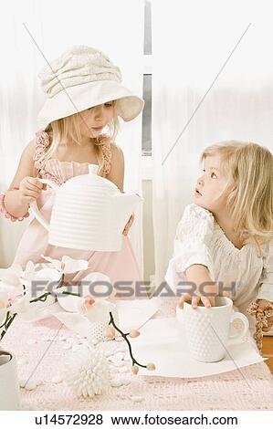 Stock Photo - Two girls having a tea party. Fotosearch