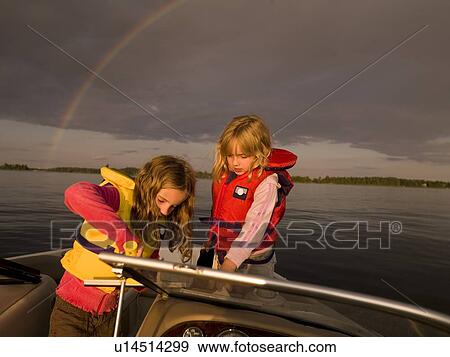Two girls on a boat View Large Photo Image Stock Photo - Two girls on a boat. Fotosearch