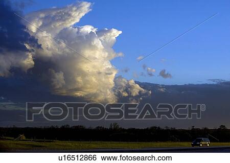 Vehicle driving by a flat landscape View Large Photo Image Stock Photograph - Vehicle driving by a flat landscape. Fotosearch