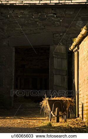 Wheelbarrow beside a barn View Large Photo Image Stock Image - Wheelbarrow beside a barn. Fotosearch