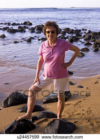 Stock Photo - Woman at the beach, Kauai, Hawaii, USA. Fotosearch