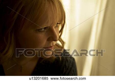 Stock Photography - Woman looking out the window. Fotosearch
