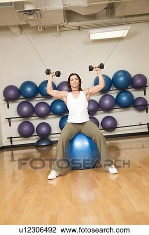 Stock Image - Woman toning muscles. Fotosearch