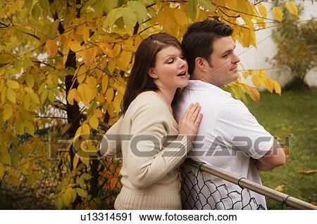 Woman trying to pull a man astray View Large Photo Image Stock Image - Woman trying to pull a man astray . Fotosearch