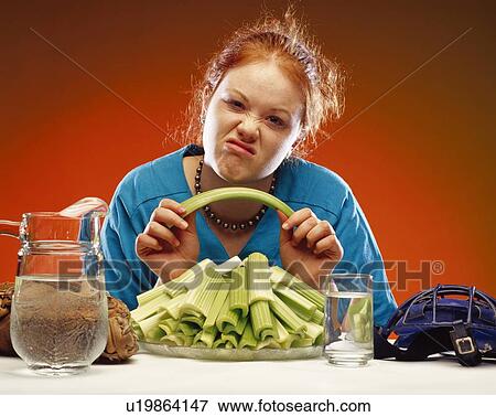 Women with plate of celery and sports equipment View Large Photo Image Stock Photo - Women with plate of celery and sports equipment. Fotosearch