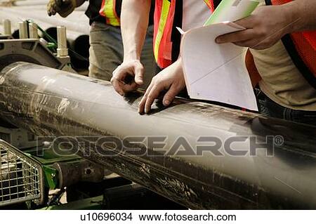 Picture - Workmen Discussing A Job. Fotosearch