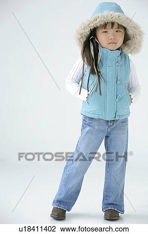 Stock Image - Young girl in winter clothing. Fotosearch
