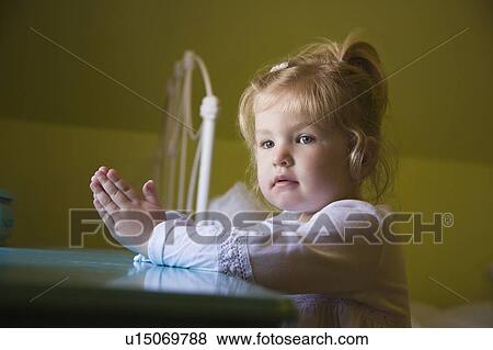 Young girl praying View Large Photo Image Stock Photo - Young girl praying. Fotosearch
