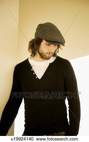 Young man looking down View Large Photo Image Stock Image - Young man looking down. Fotosearch