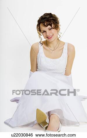 Stock Photograph - Young woman in a white dress. Fotosearch
