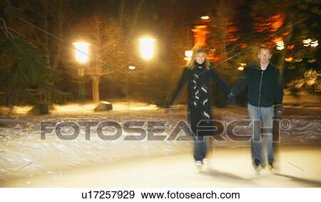 Stock Photo - A couple go skating. Fotosearch