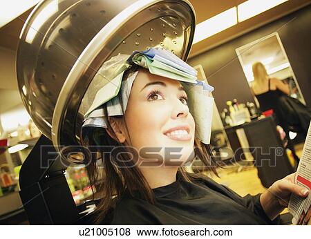 Stock Photo - A young woman in a hair salon A young woman in a hair-salon A young woman in a hair salon. Fotosearch