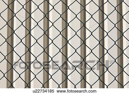 Barbed wire fence and wall behind View Large Photo Image Stock Photography - Barbed wire fence and wall behind. Fotosearch