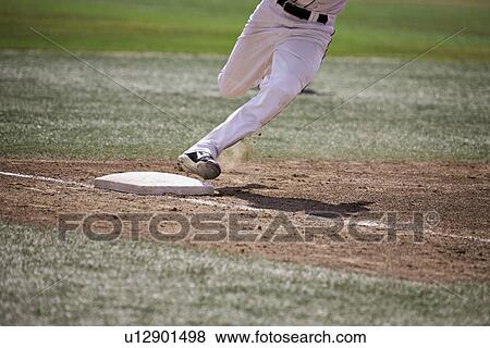 Stock Photo - Baseball player running home. Fotosearch