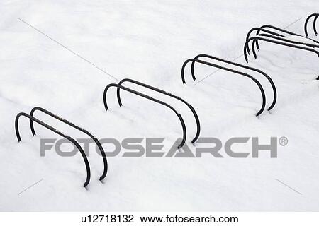 Bicycle racks partially buried in snow View Large Photo Image Stock Image - Bicycle racks partially buried in snow. Fotosearch