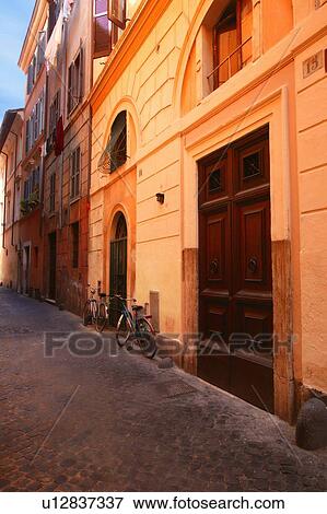 Bicycles on street in front of Buildings Rome Italy View Large Photo Image Stock Photo - Bicycles on street in front of Buildings Rome Italy. Fotosearch