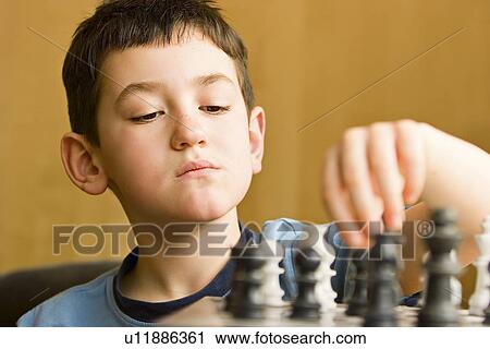 Boy playing chess View Large Photo Image Stock Image - Boy playing chess. Fotosearch