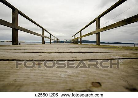 British Columbia, Canada; Surface level view of wooden dock, with a view into land View Large Photo Image Stock Photograph - British Columbia, Canada; Surface level view of wooden dock, with a view into land. Fotosearch