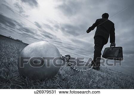 Stock Image - Businessman with ball and chain. Fotosearch
