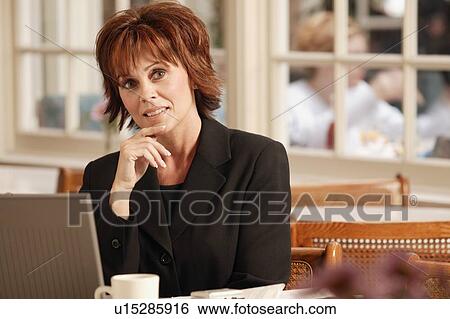 Stock Photograph - Businesswoman in cafe. Fotosearch