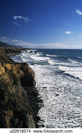Picture - California, USA; Waves crashing against cliffs. Fotosearch