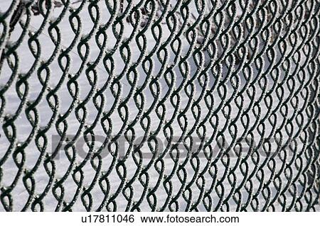 Stock Photograph - Chain link fence covered in frost. Fotosearch