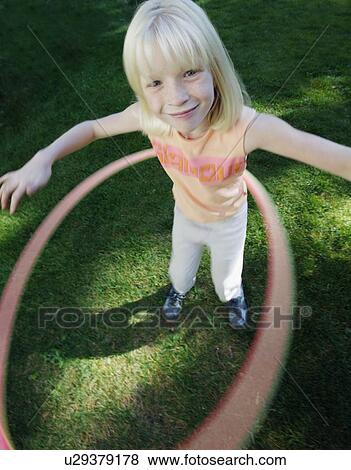 Stock Photo - Child plays with hoop. Fotosearch