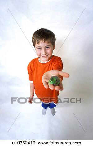 Child with a green frog View Large Photo Image Stock Photo - Child with a green frog. Fotosearch