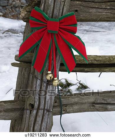 Christmas Decorations On An Old Wooden Fence Outside In The Snow