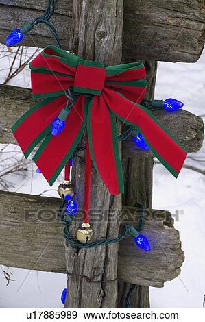 Christmas decorations on an old wooden fence outside in the snow View Large Photo Image Stock Photo - Christmas decorations on an old wooden fence outside in the snow. Fotosearch