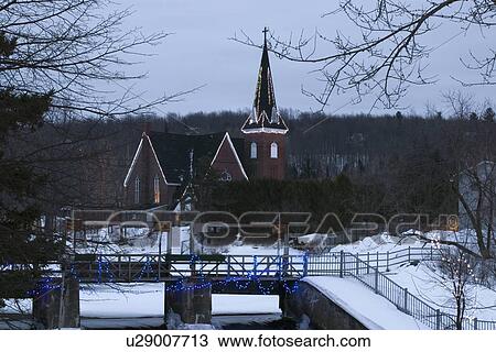 Christmas lights decorating a snow covered church and bridge View Large Photo Image Stock Image - Christmas lights decorating a snow covered church and bridge. Fotosearch