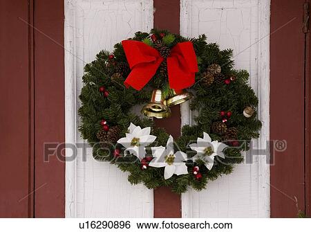 Stock Photograph - Christmas wreath hanging on a door. Fotosearch