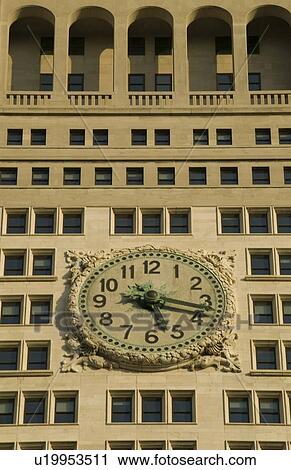 Stock Image - Clock on the side of a building. Fotosearch