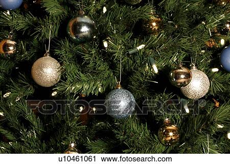 Stock Image - Close up of a Christmas tree covered in decorations. Fotosearch